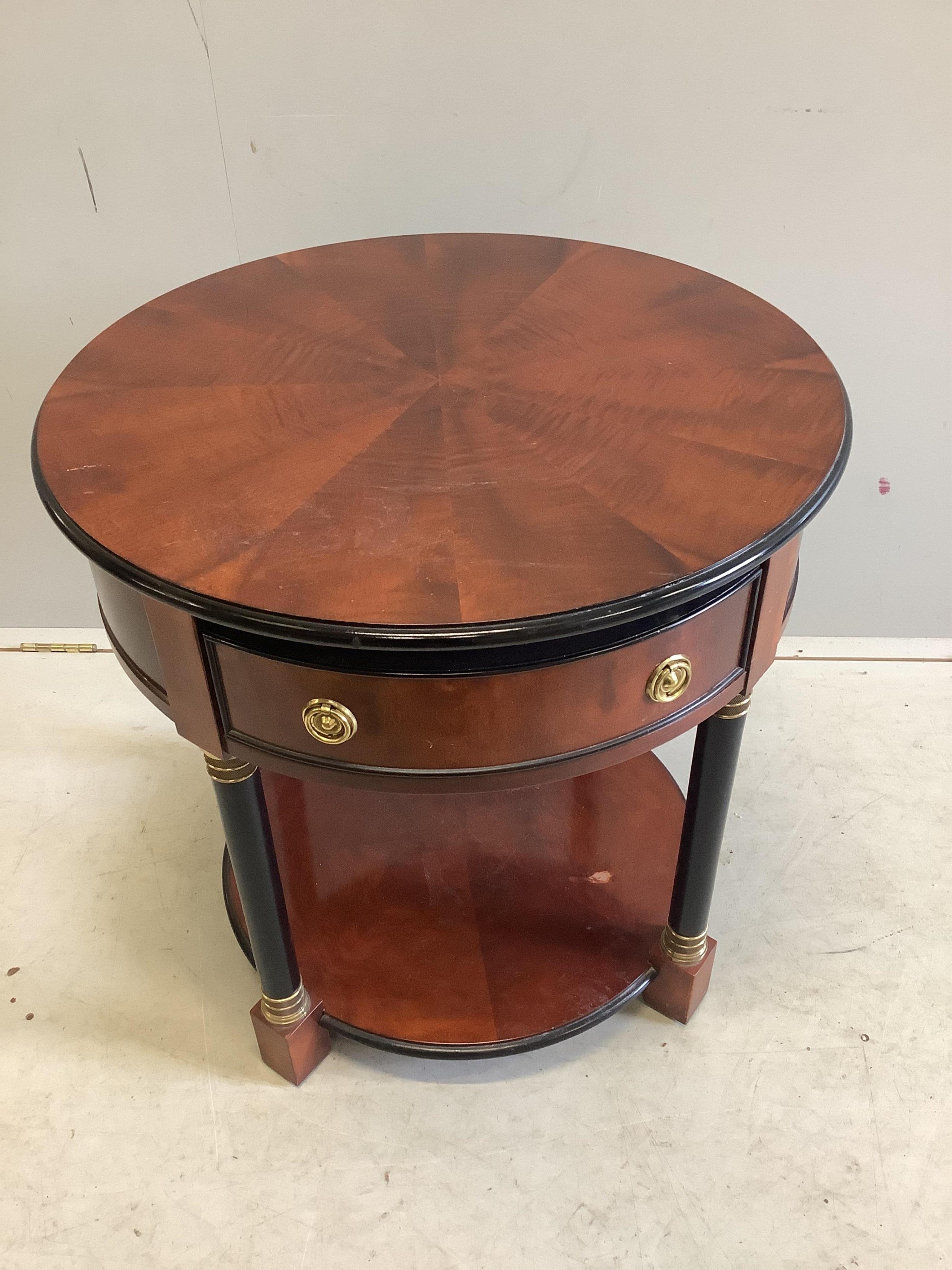 A pair of French Empire style mahogany and ebonised two tier circular tables, diameter 65cm, height 54cm. Condition - fair